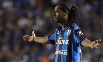 Queretaro's Ronaldinho gestures during a Copa MX soccer match against Tigres in Queretaro